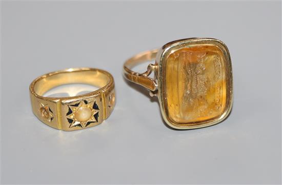 A Victorian yellow metal and enamel ring and a Victorian yellow metal and citrine intaglio ring inscribed Gone Away with fox.